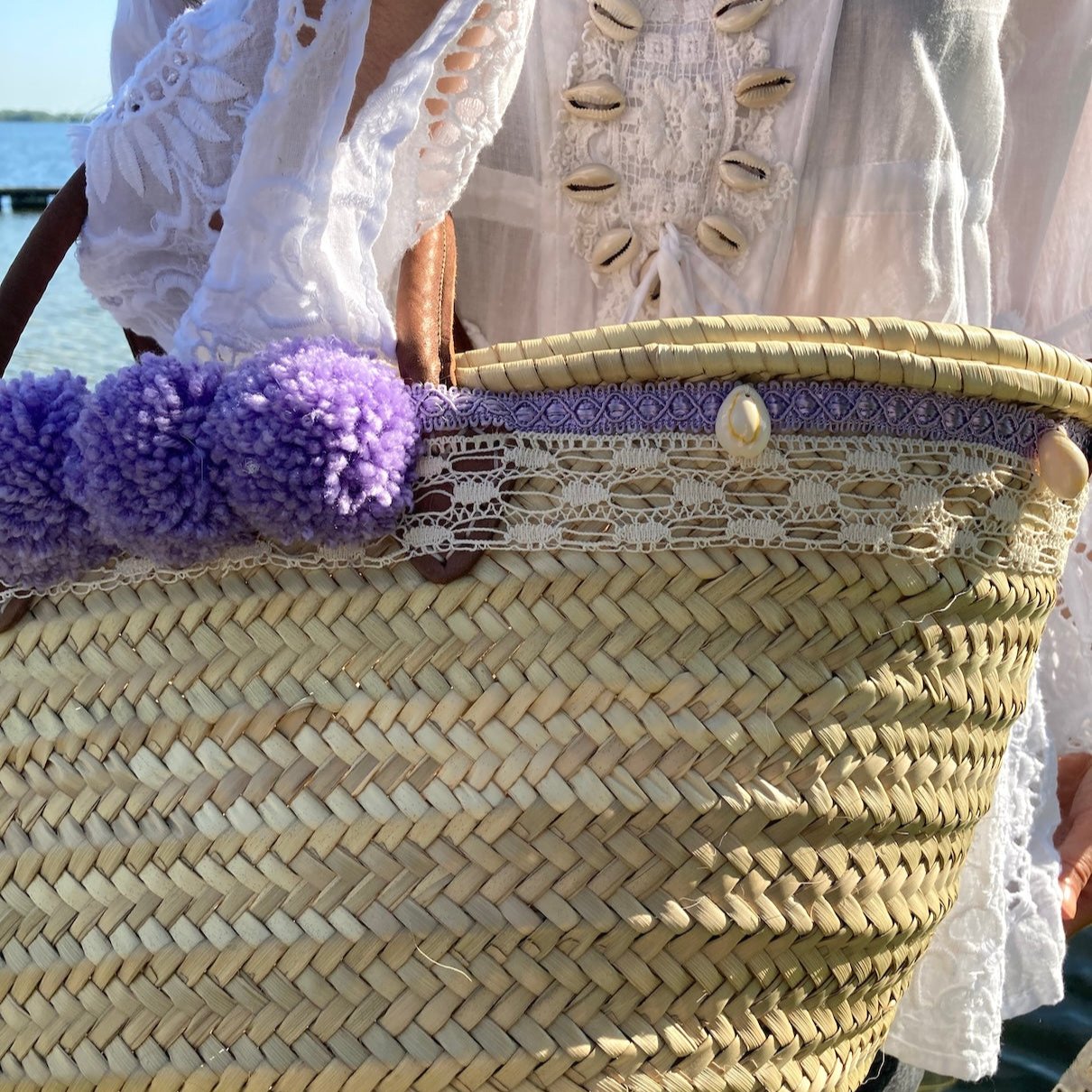 Handgemaakte grote rieten strandtas uit de Ibiza collectie met pompons en schelpen